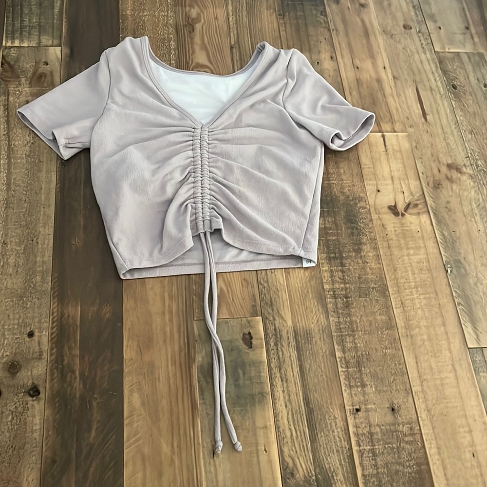 This is a light purple shirt from Five Dancewear. Size YXL.